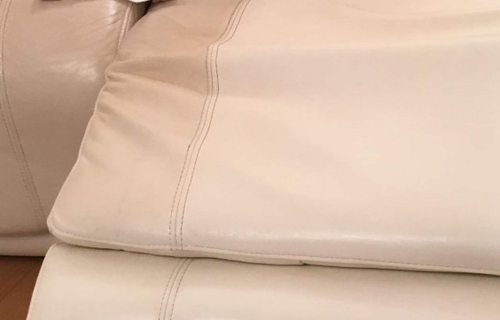 "Specialized leather cleaning by Dirt Busters, restoring a leather chair to its original luster."