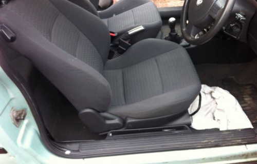 "Dirt Busters cleaning car upholstery, restoring a vehicle interior with precision."